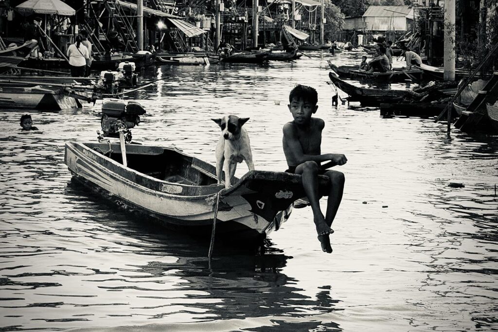 Smartphone photography, kid on a boat with his dog